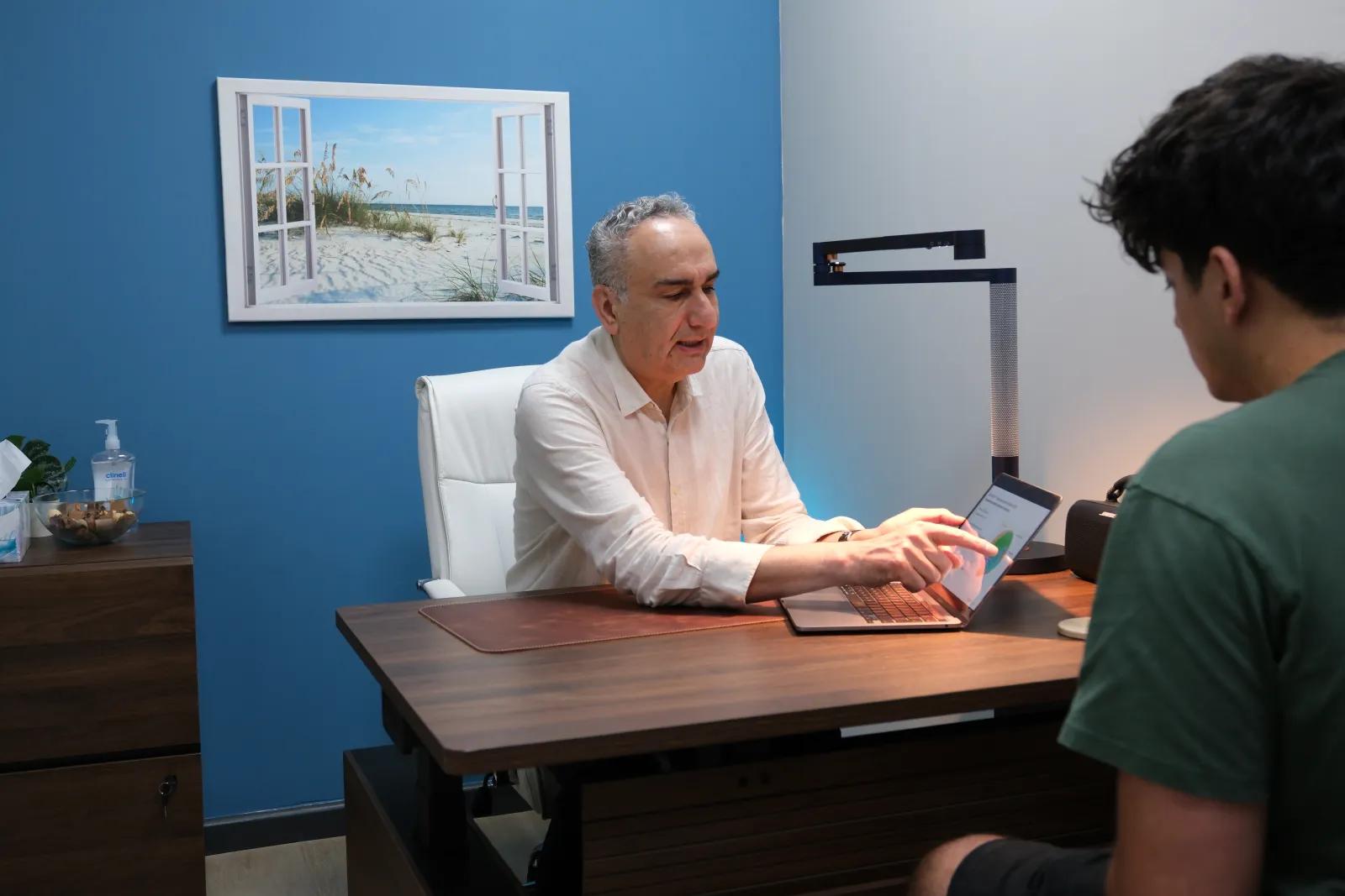 Dr Behrouz Nabavi in consultation with a patient at Birmingham Neuromodulation Clinic