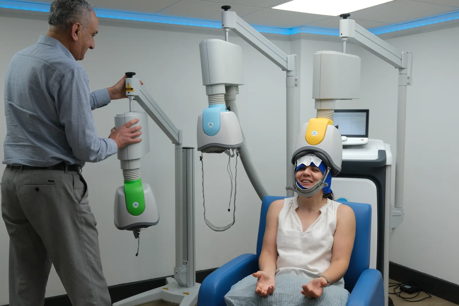 Dr Behrouz Nabavi adjusting the position of the Deep TMS coil