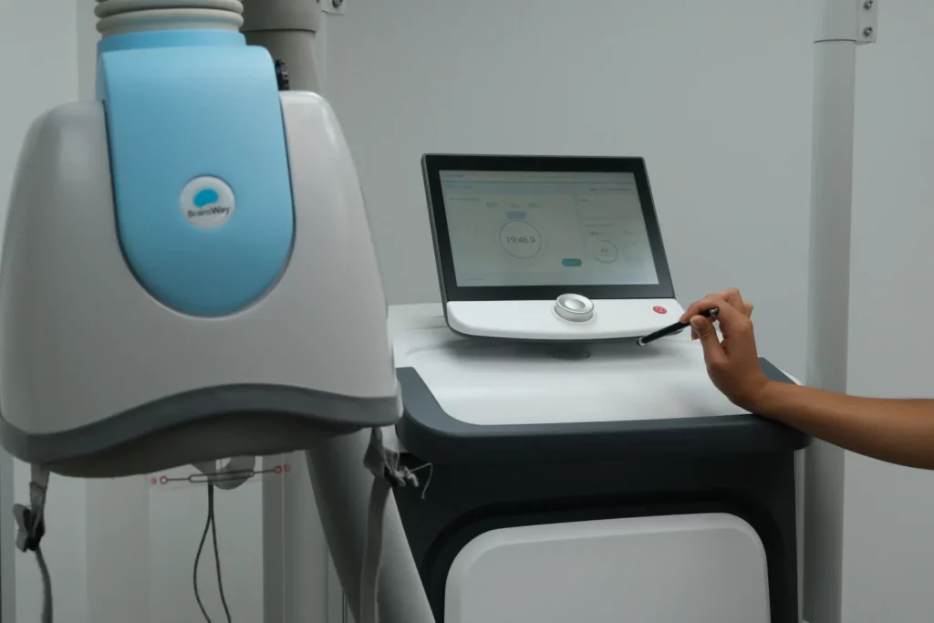 The Deep TMS system console and coil helmet