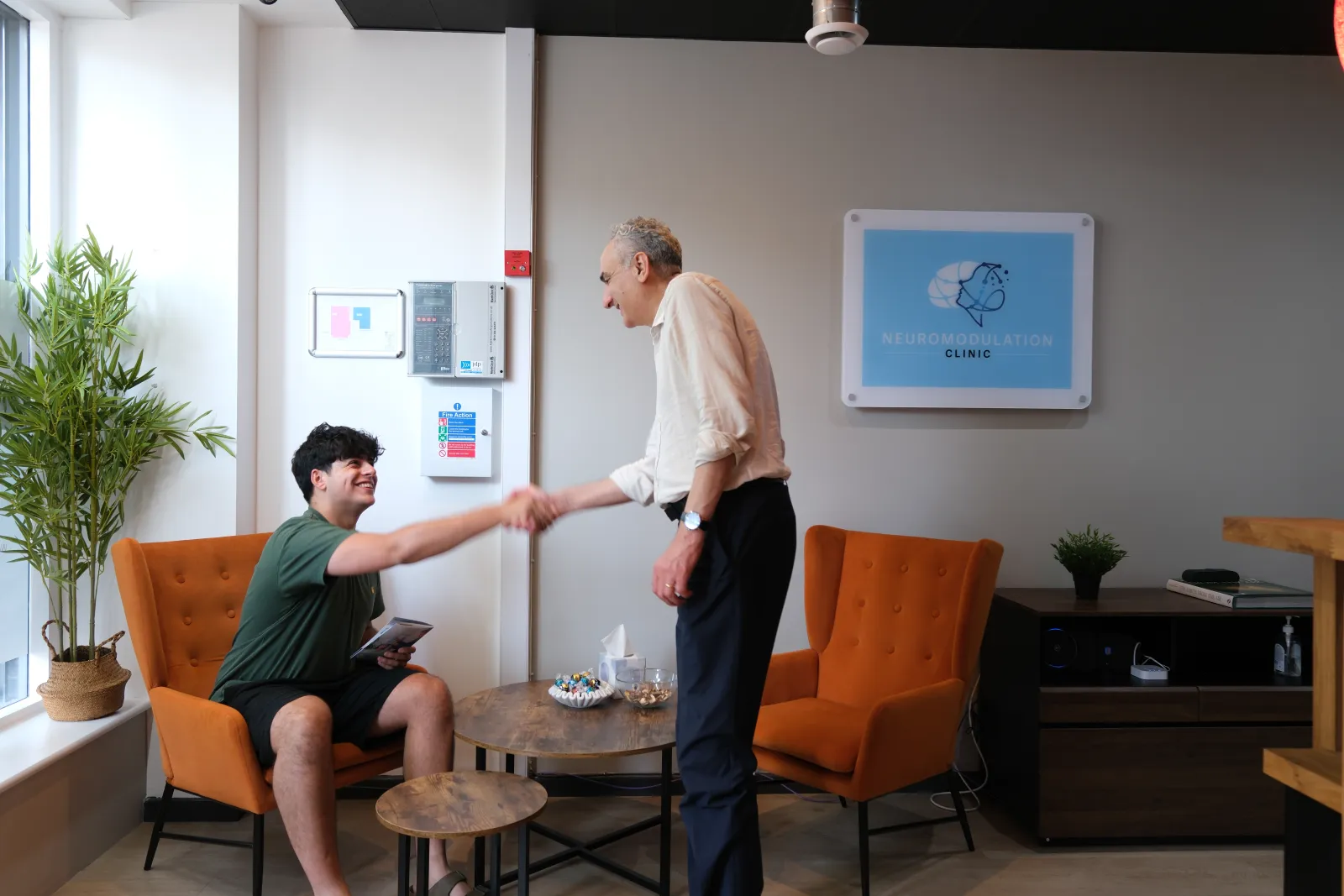 Dr Behrouz Nabavi greeting a patient in the waiting area